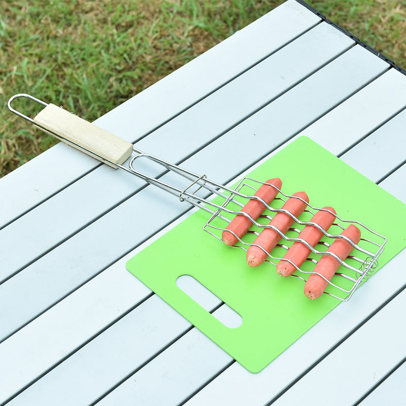 Hot dogs on a grill basket on a green cutting board with a wooden table background
