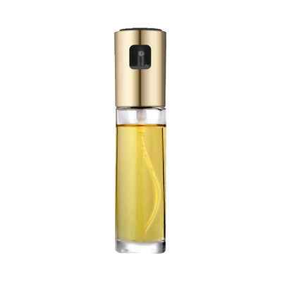 Gold and clear cosmetic bottle with yellow liquid on a white background