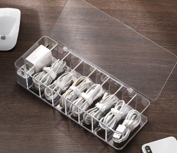 Clear cable organizer with electronic cords on a wooden desk