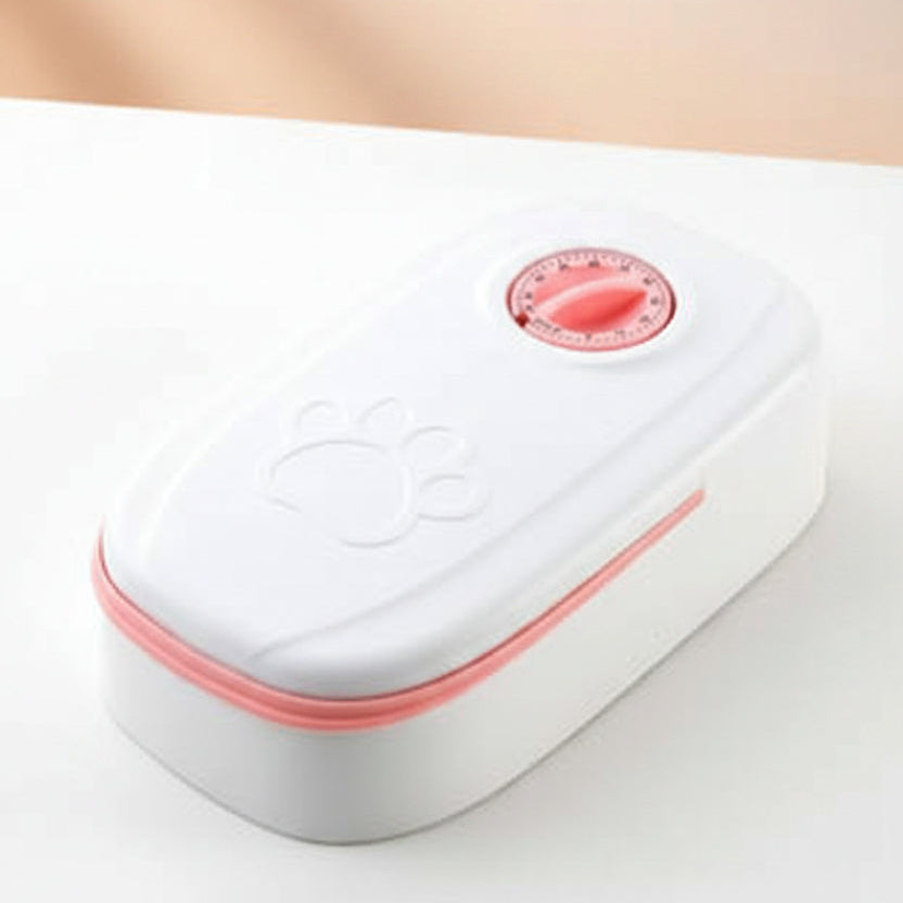 Small white electronic device with a red button on a light gray background