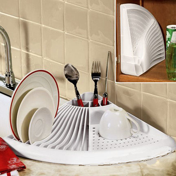 White dish drying rack with dishes and utensils on a kitchen counter.