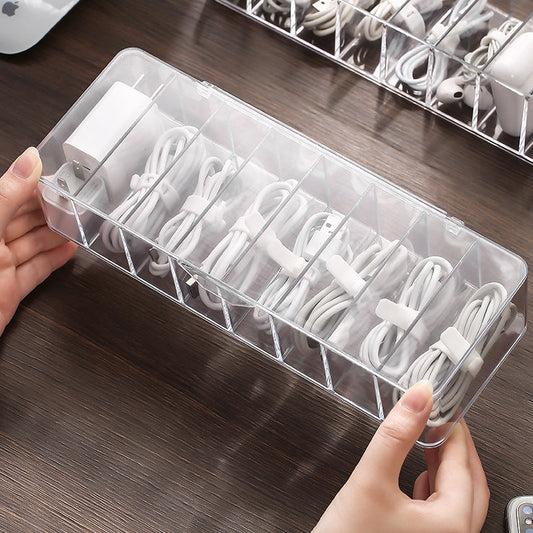 Clear cable organizer with white cables on a wooden surface