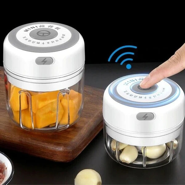 Two small food choppers with ingredients inside on a dark surface.