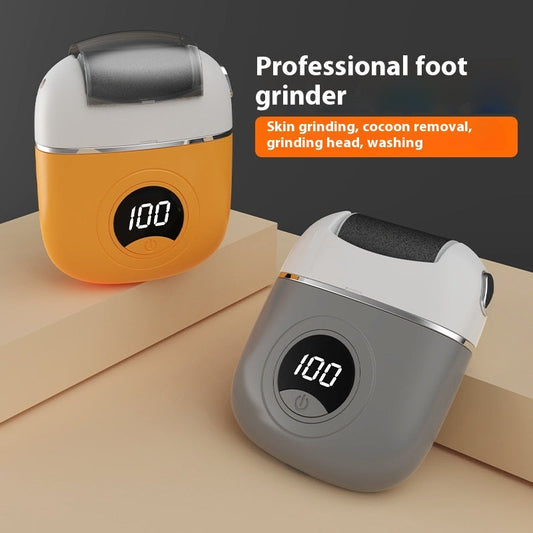 Two foot grinders with digital displays on a beige surface and dark background