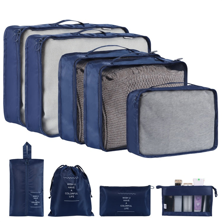 Set of blue and gray packing cubes with a small bag and pouch on a white background