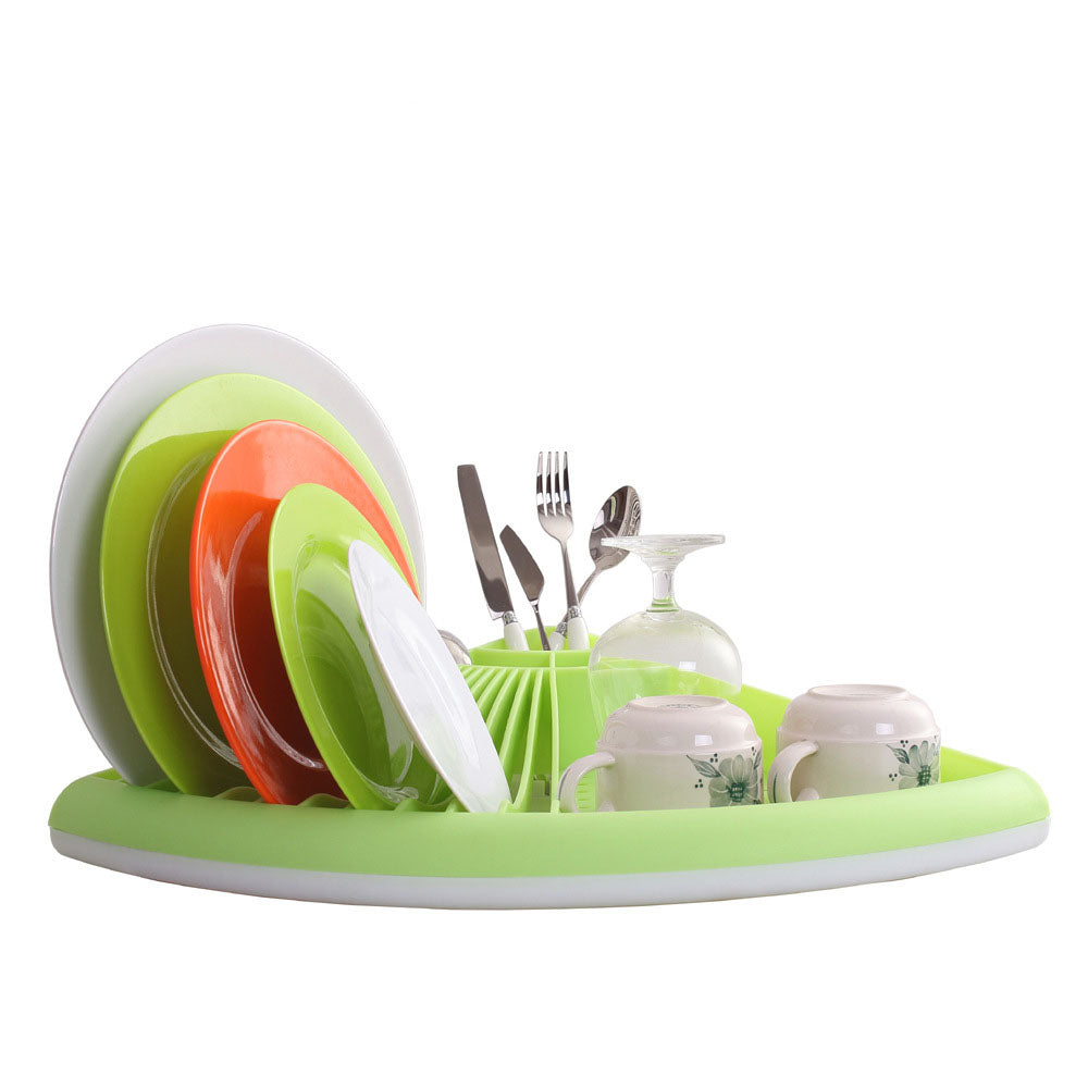 Green dish drying rack with plates, cups, and utensils on a white background