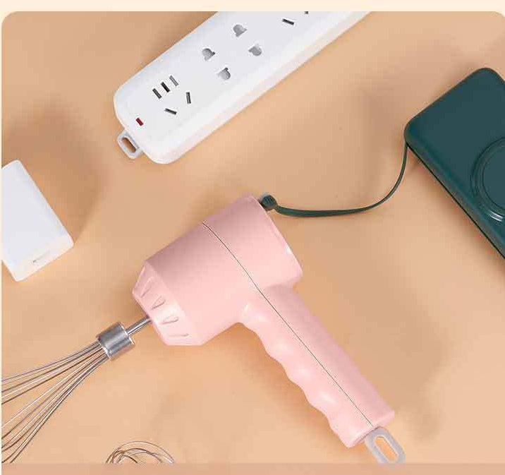 Pink handheld hair dryer with a whisk attachment on a beige surface.