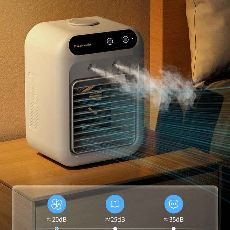 Portable air cooler emitting mist on a wooden surface with control panel icons displayed.