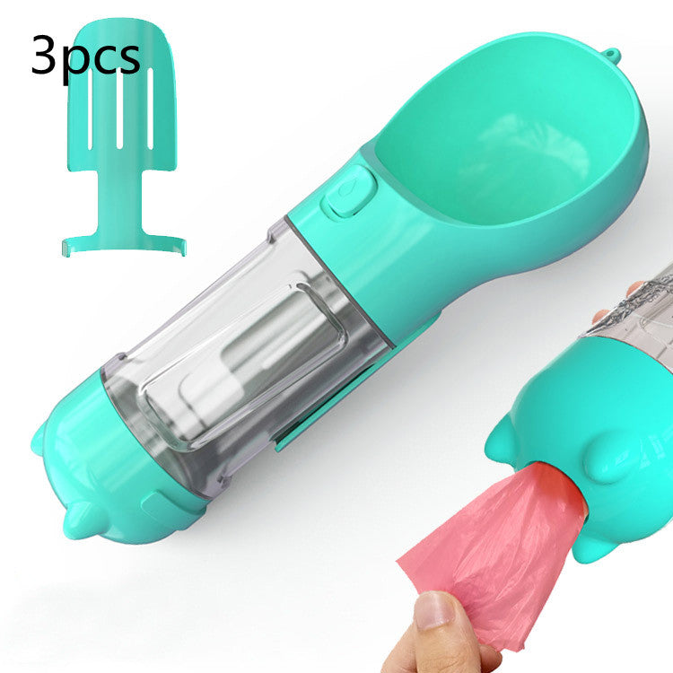 Turquoise pet feeder with clear compartment and pink scoop on a white background