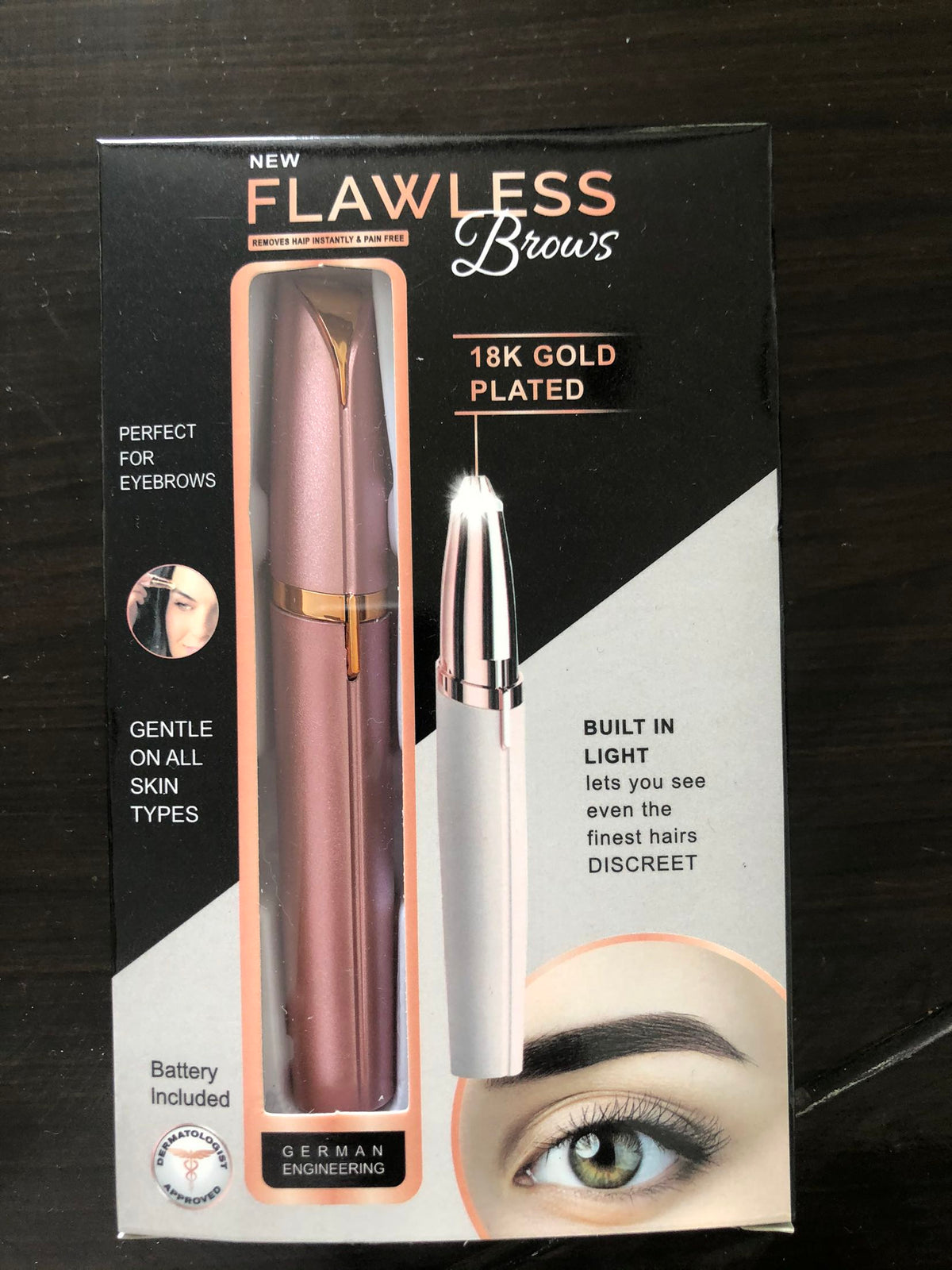 Flawless Brows packaging with an eyebrow pencil on a dark background