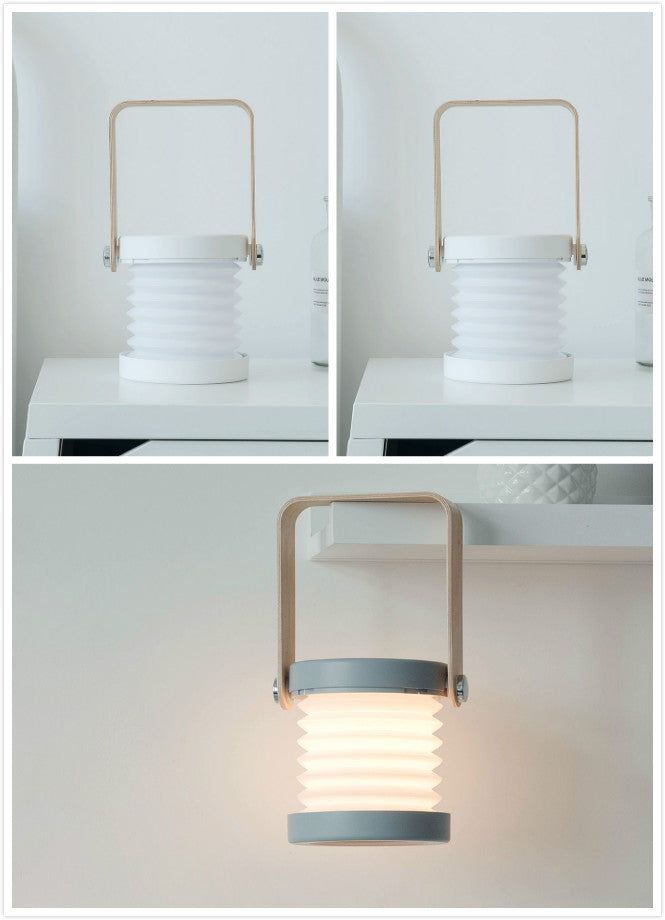 Modern outdoor lamp with white shade and metal handle on a light gray background