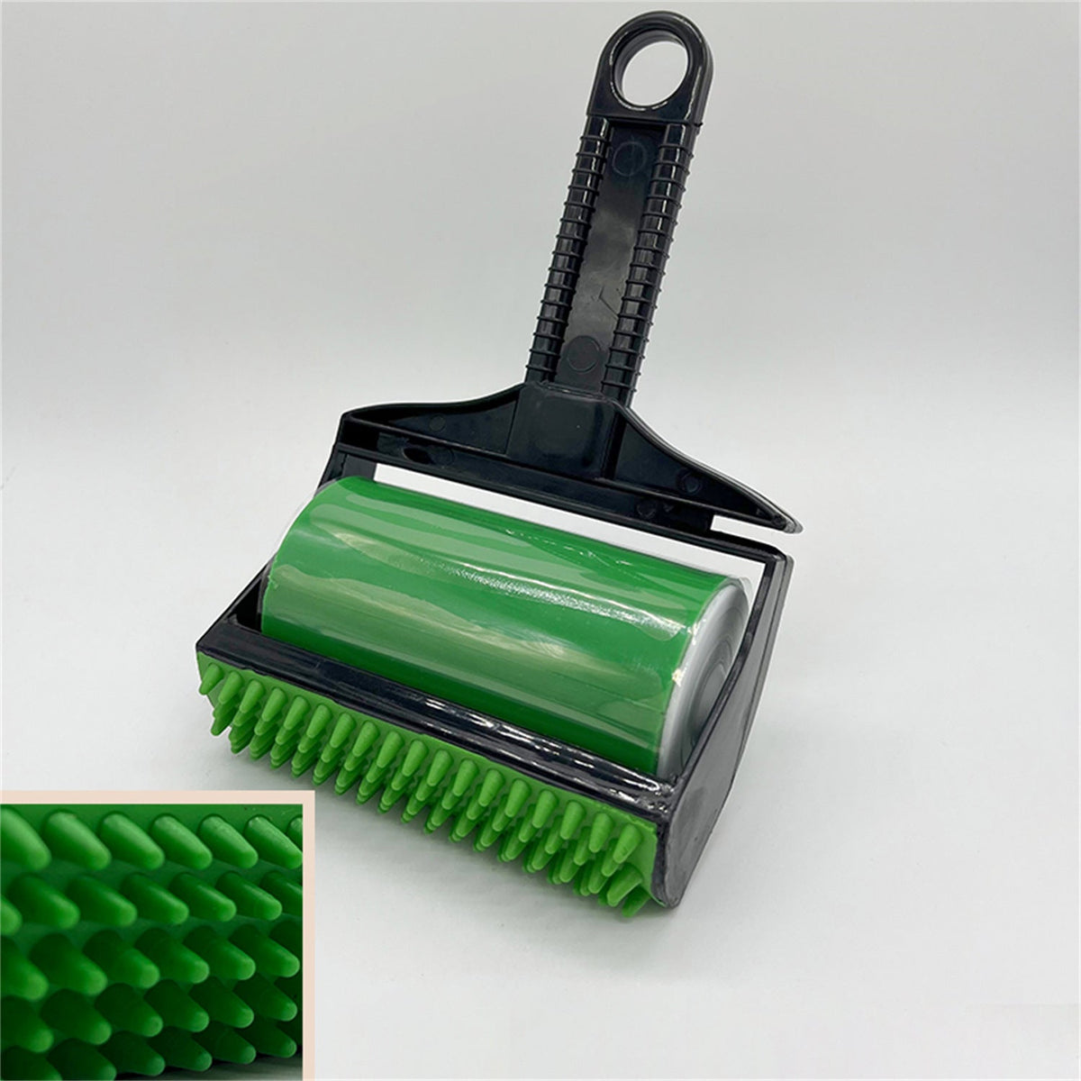 Green and black pet grooming brush with close-up inset on a white background