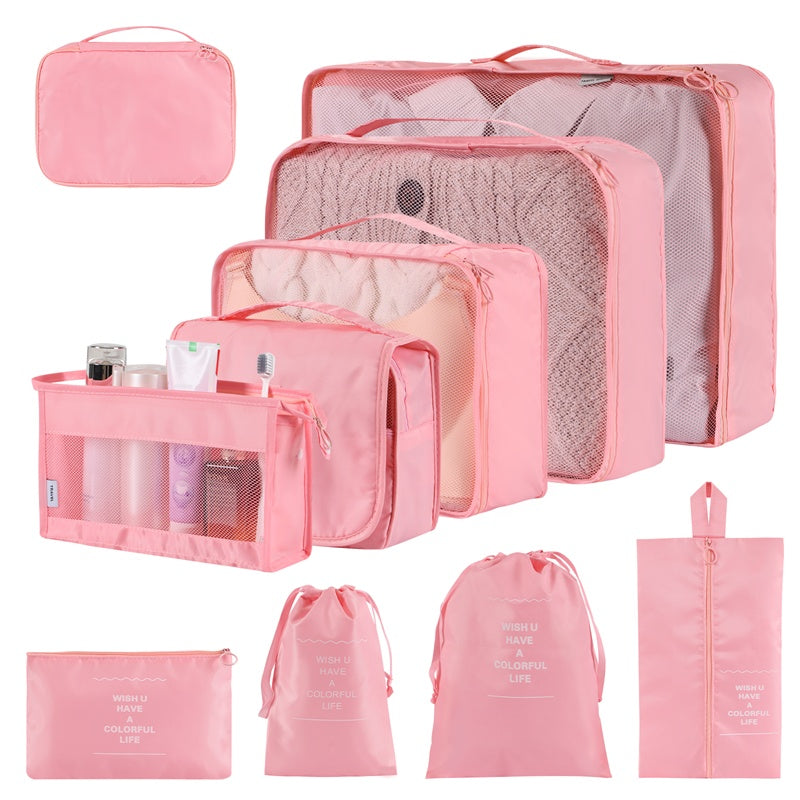 Set of pink travel packing cubes and bags on a white background