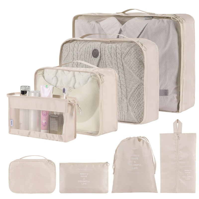 Set of beige travel packing cubes and bags on a white background