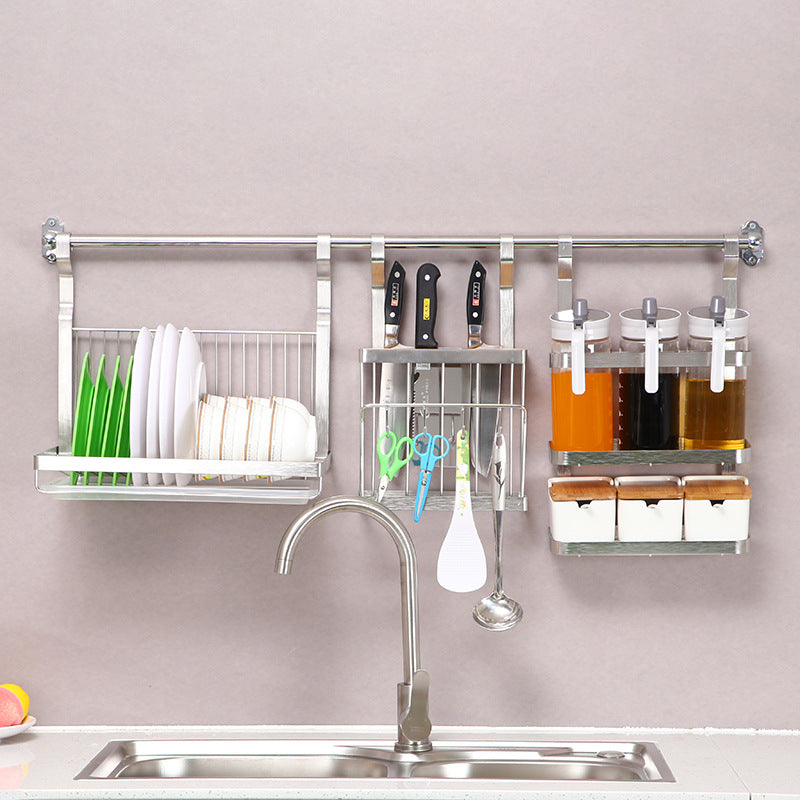 Kitchen wall-mounted organizer with shelves and hooks on a neutral background