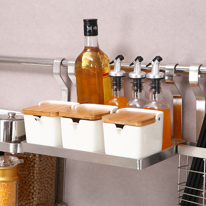 Kitchen storage rack with bottles and containers on a neutral background