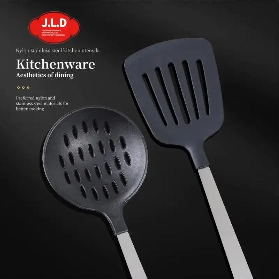 Two dark gray kitchen utensils, a slotted spoon and a spatula, with long silver handles, displayed on a black background with J.L.