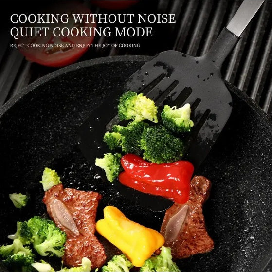 A black silicone spatula with a silver handle is shown lifting broccoli and steak from a black frying pan with red and yellow peppers. White text at the top reads 'COOKING WITHOUT NOISE QUIET COOKING MODE'.
