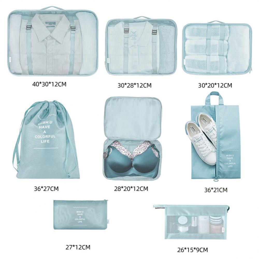 Set of blue packing cubes and bags with dimensions displayed