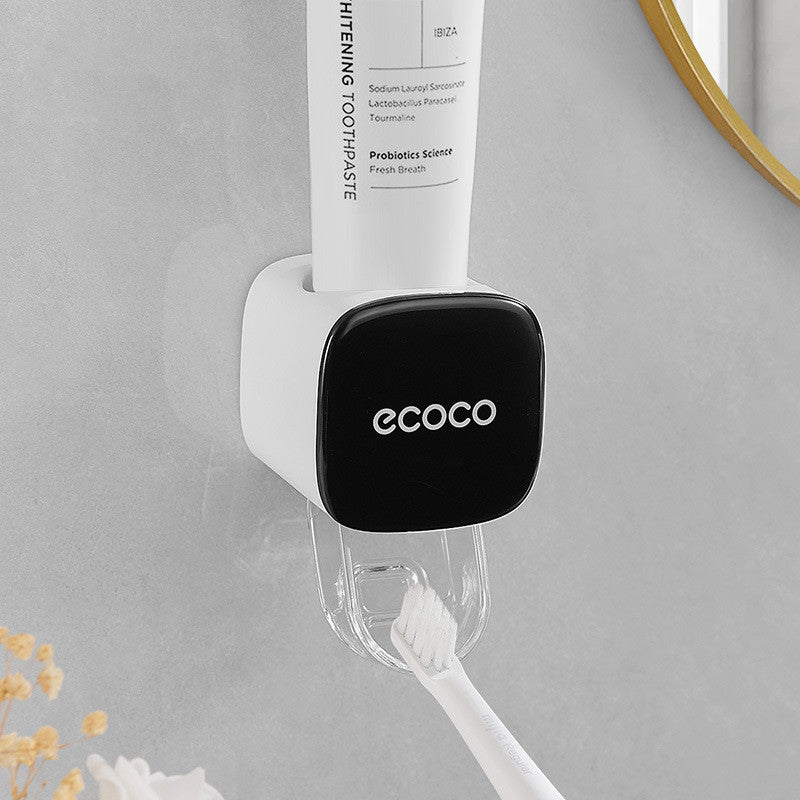 Toothpaste tube on a holder with 'ecoco' branding in a bathroom setting.