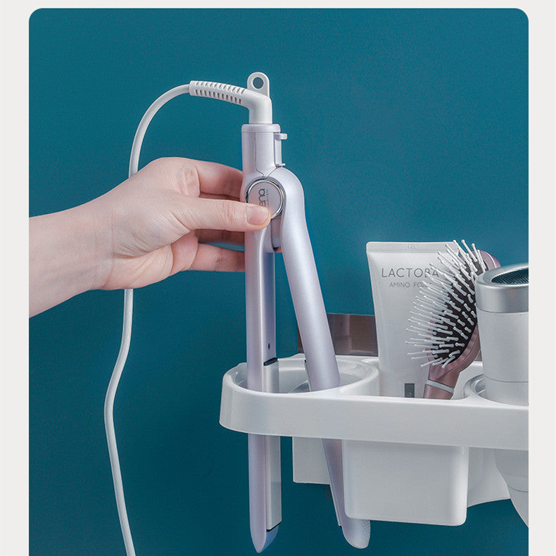 Hand holding a white hair straightener on a blue background with a white shelf.