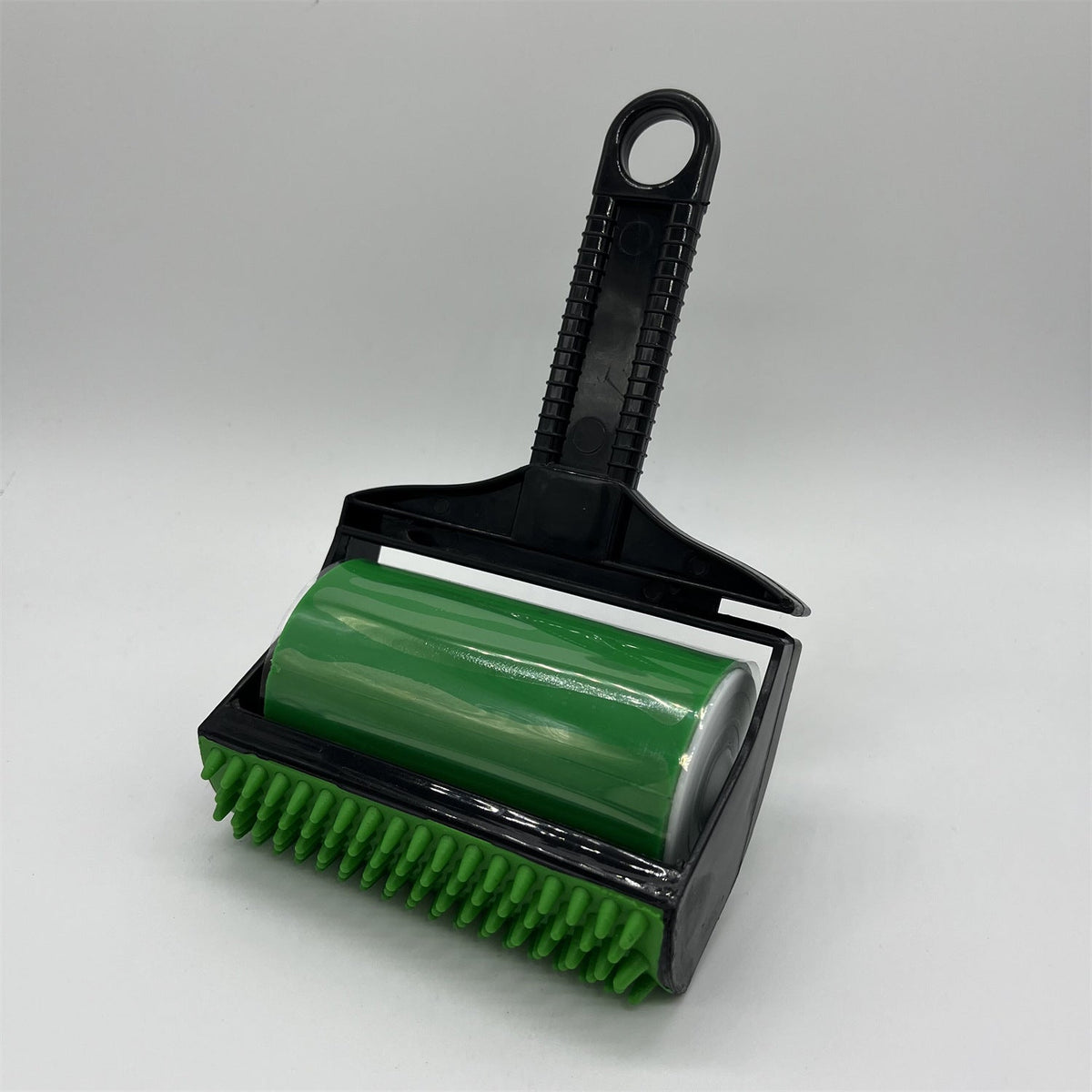 Green brush with black handle on a white background